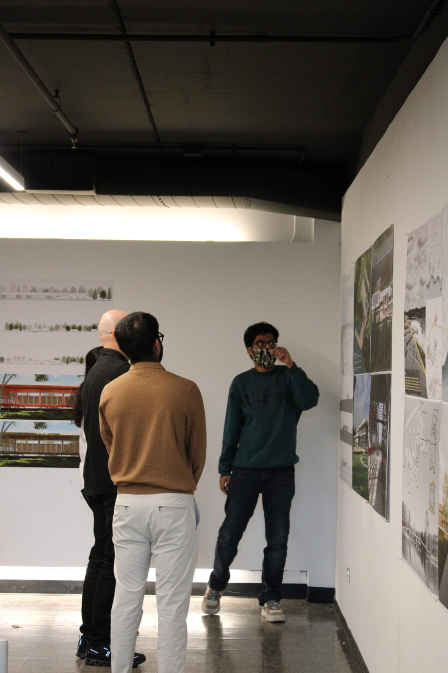a student presenting posters for three other people