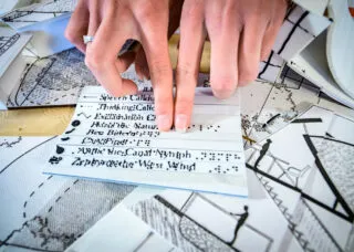 hands run across raised text