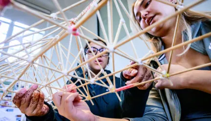 two people hold a truss