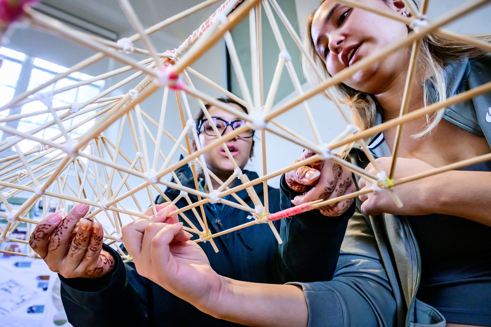 two people hold a truss