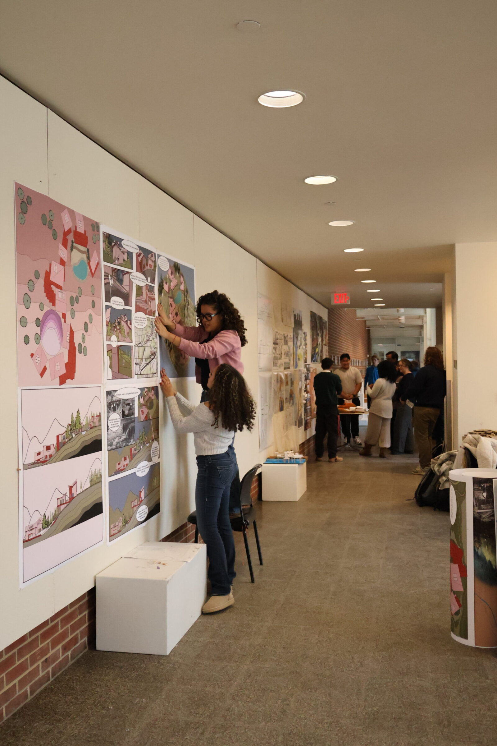 students pinning up projects