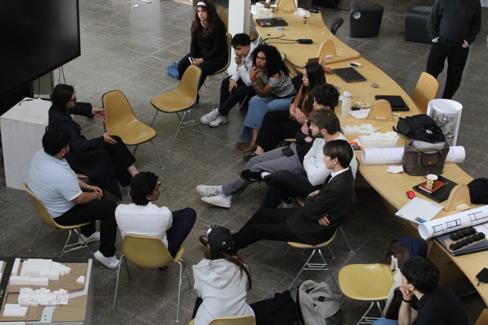 Students and professors sitting in a circle talking