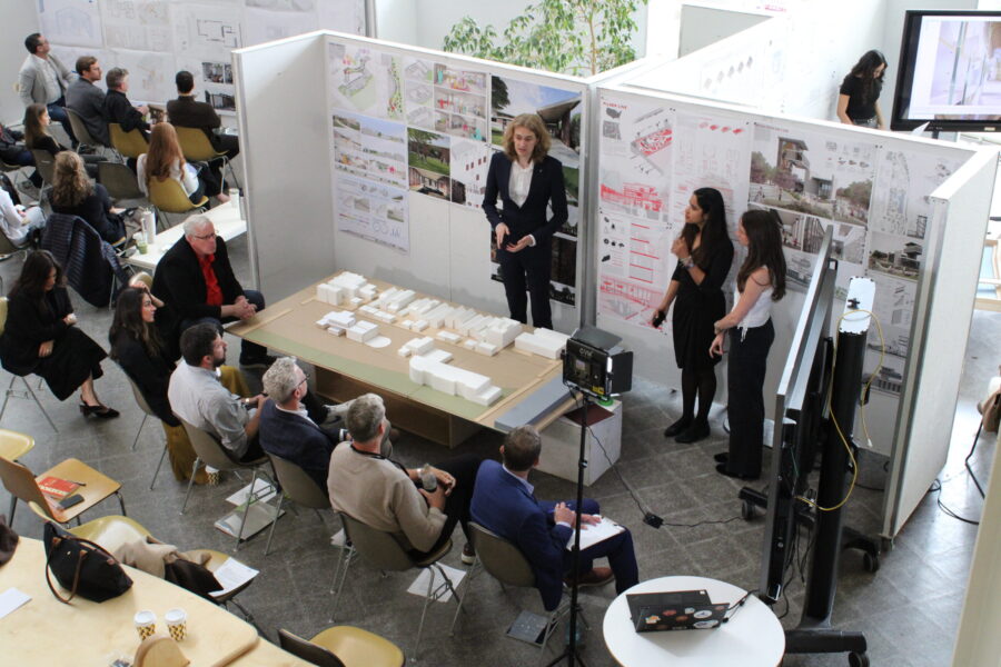 students presenting their architecture drawings and model to reviewers