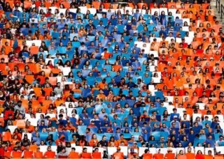 orange white and blue I made up of students at a football game