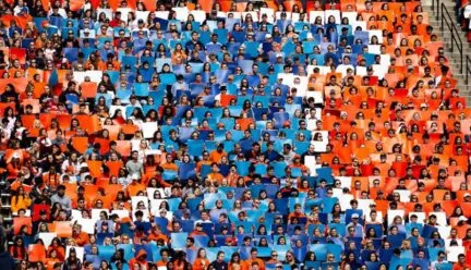 orange white and blue I made up of students at a football game