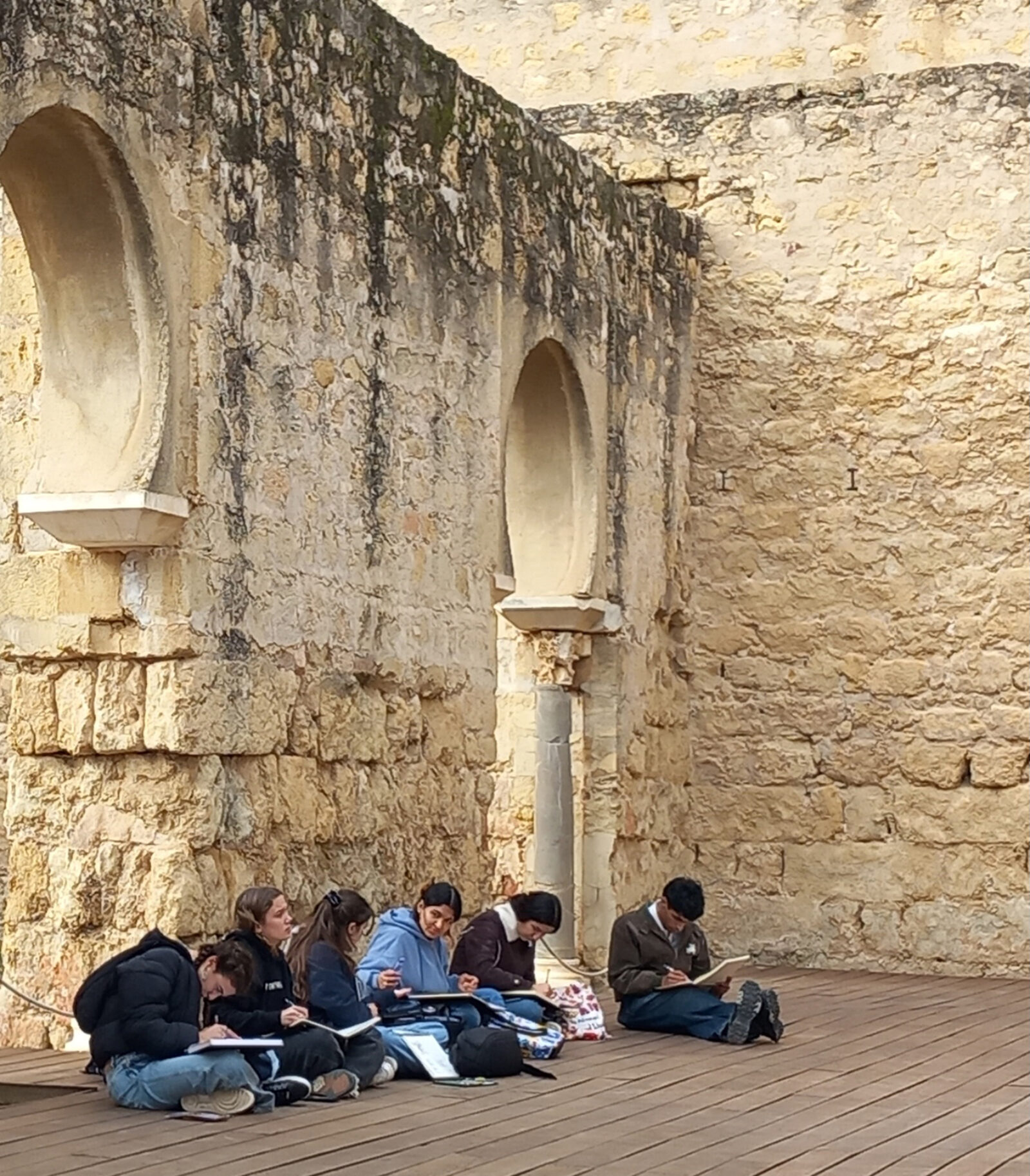 students sitting in beautiful arch place