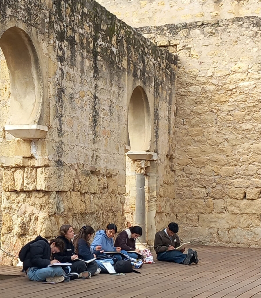 students sitting in beautiful arch place