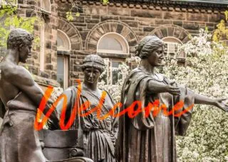 jpg welcome with three brass statues interacting
