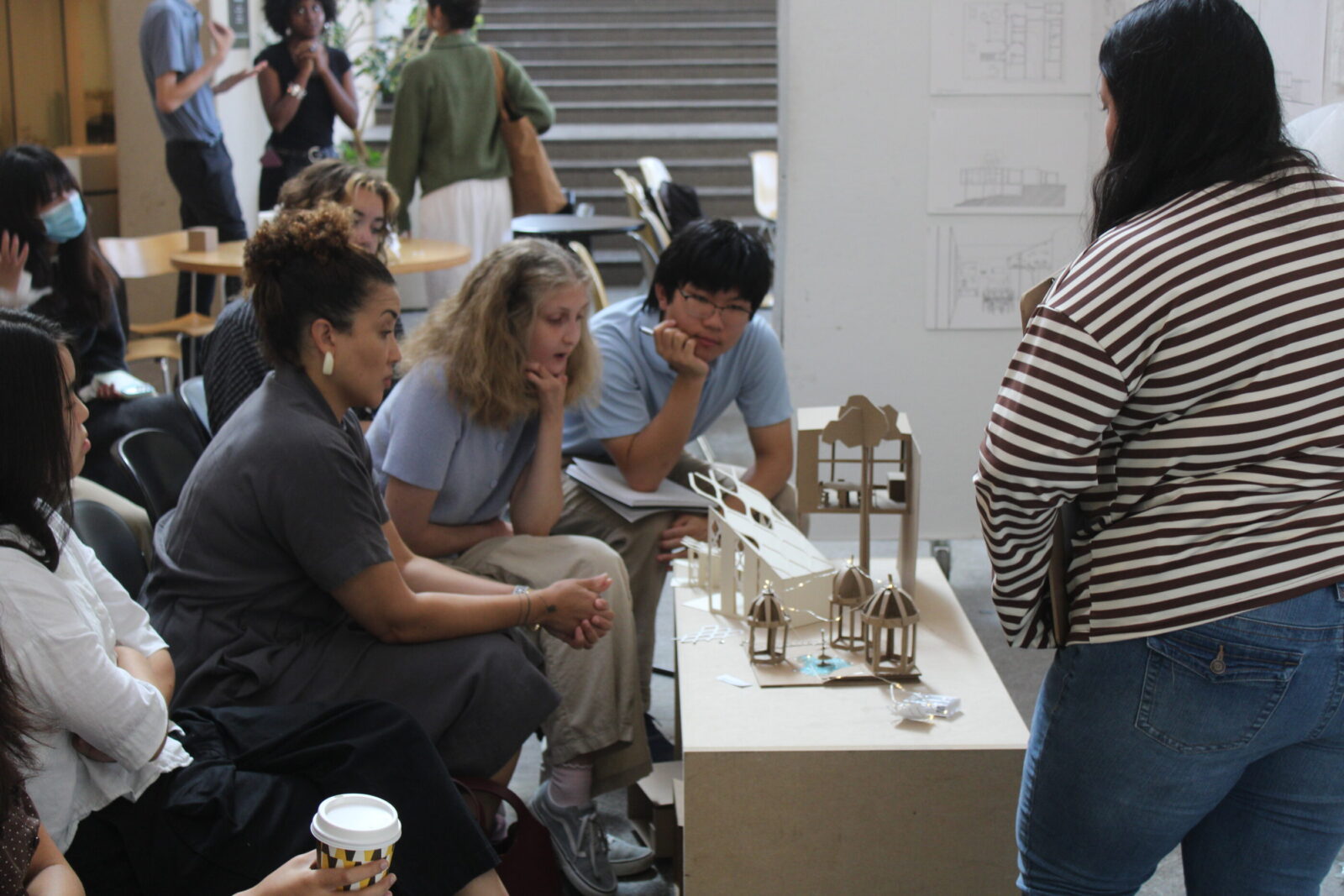 professor and students looking at physical model 