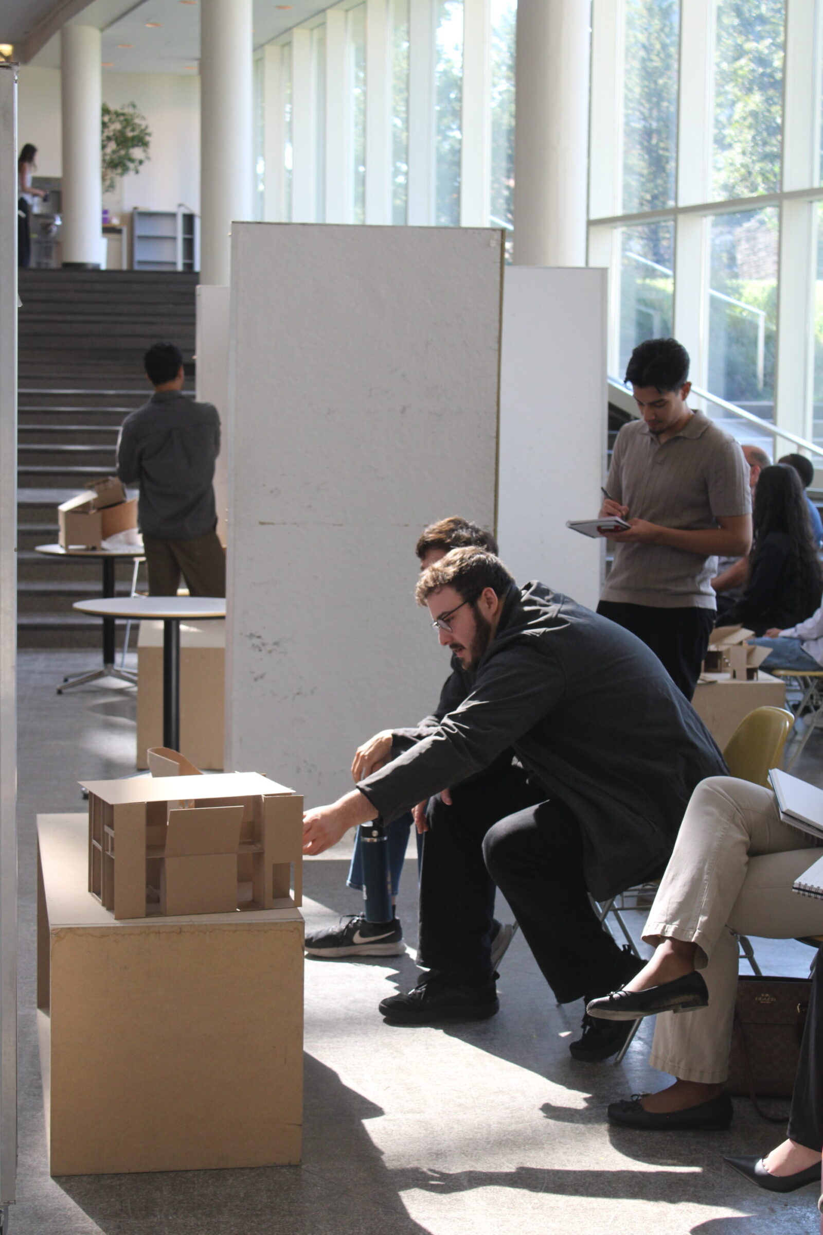 reviewer looking at student's physical model 
