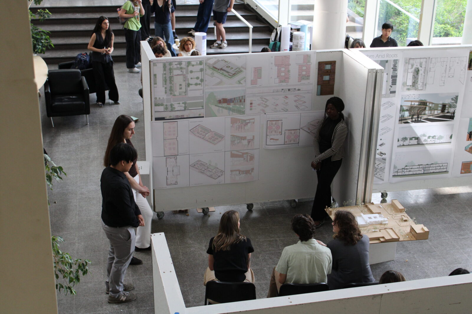 students presenting work to professors