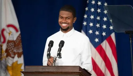 Amaury Saulsberry at a podium