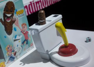 Toy toilet and plunger with poop book
