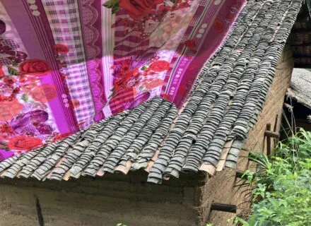 Pink linen hanging outdoors above a rustic rooftoop