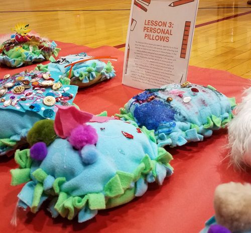 Photo of colorful pillow-shaped student artworks