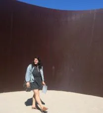 Portrait of the student walk in an immersive steel sculpture by the artist Richard Serra