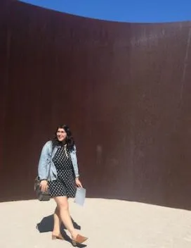 Portrait of the student walk in an immersive steel sculpture by the artist Richard Serra