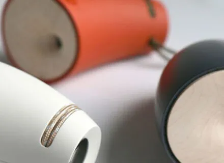 View of white, orange and grey objects on a wood tabletop