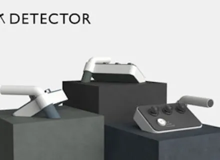 Three small white and gray electronic devices on pedestals