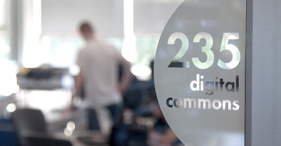 sign for 235 digital commons seen through blurry glass