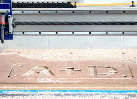 cnc cut wood with the letters "a+d"