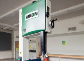 a green bandsaw in a woodshop