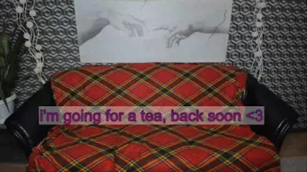 Photo of a couch covered with a red plaid blanket and the words "I'm going for a tea, back soon <3" overlaid in pink