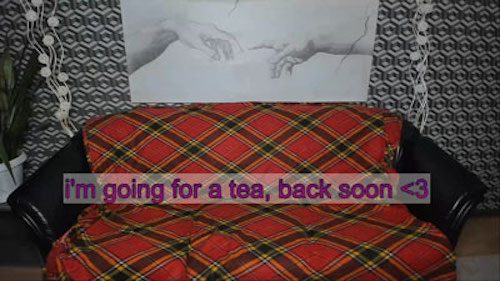 Photo of a couch covered with a red plaid blanket and the words 