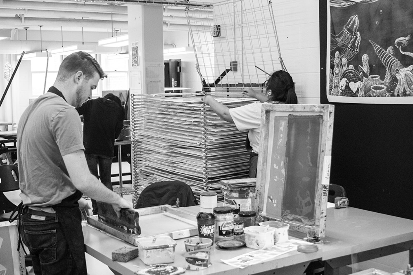 black and white photo of student screen printing