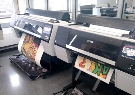 two large format inkjet printers printing artwork