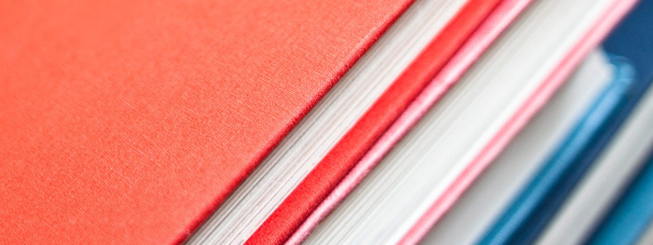 Closeup of covers and pages of a stack of hardcover books