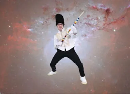 Photo of an active figure posing before a celestial background