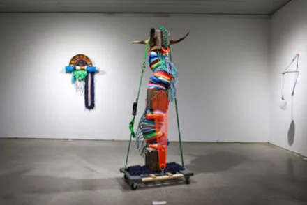Photo of gallery installation with two colorful multimedia sculptures