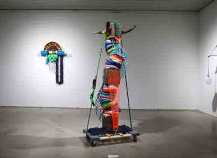 Photo of gallery installation with two colorful multimedia sculptures