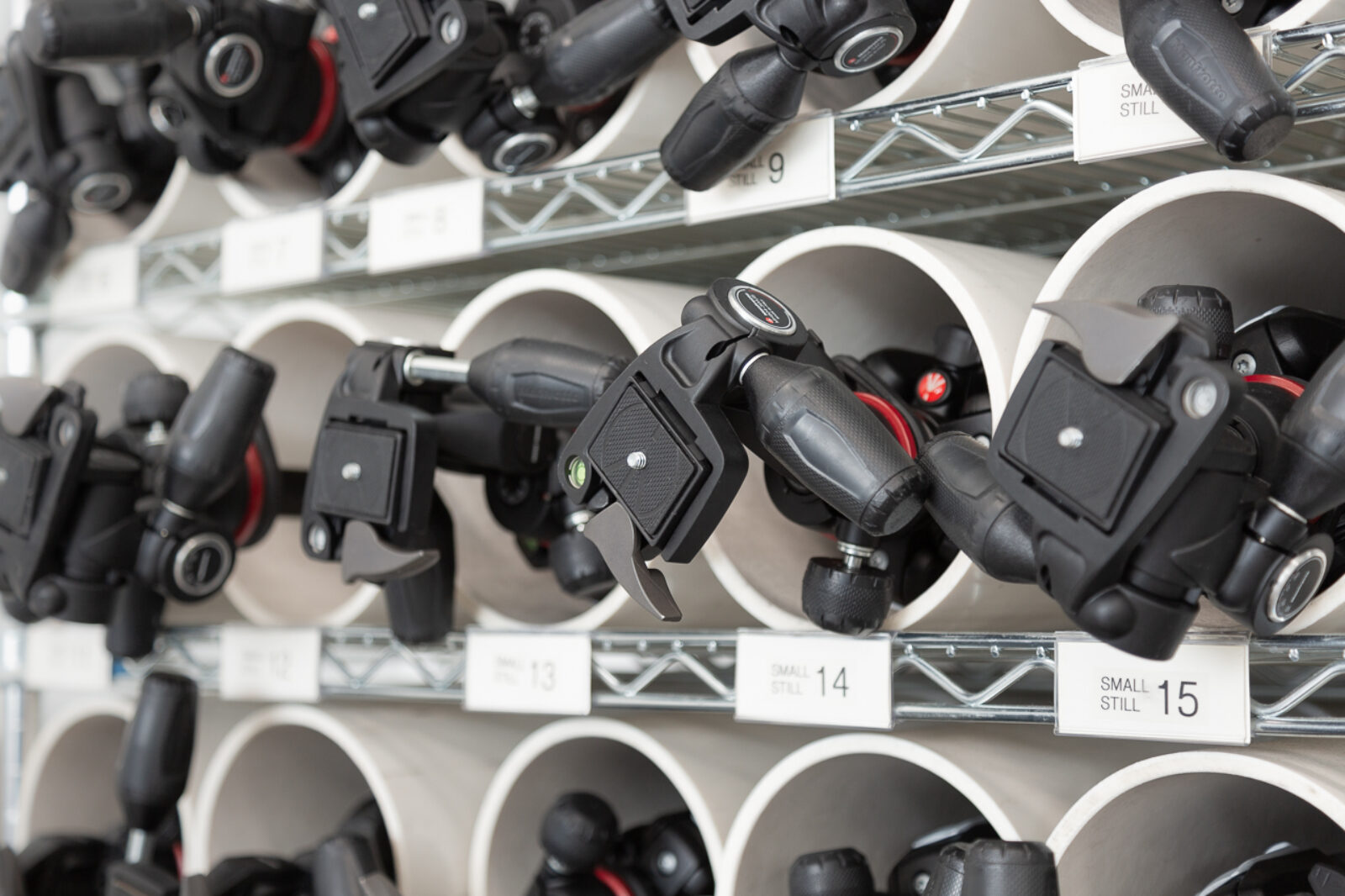 photograph of a shelf full of tripods