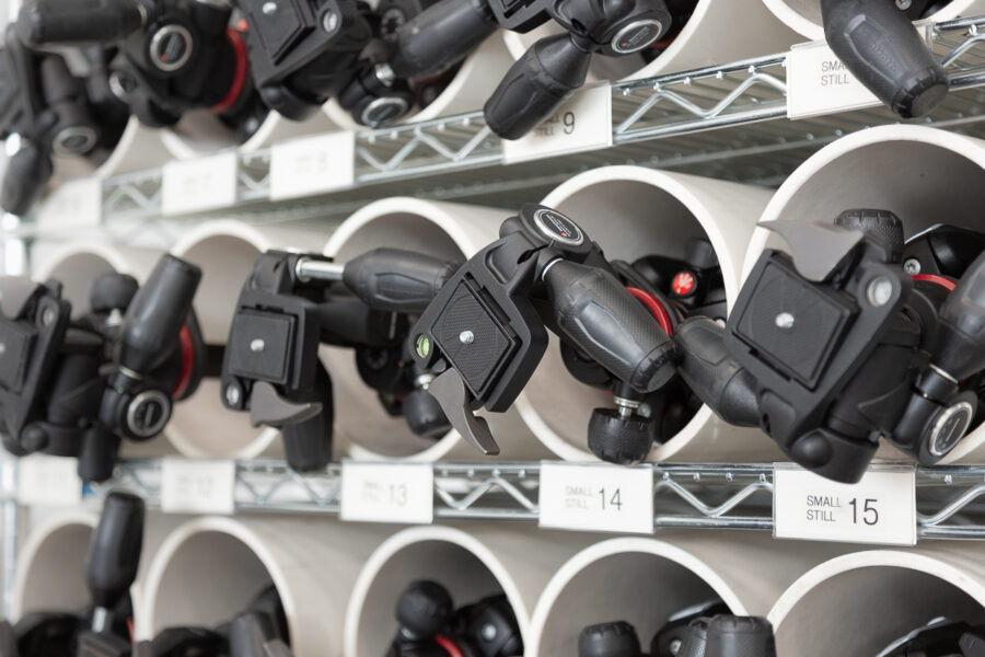 photograph of a shelf full of tripods