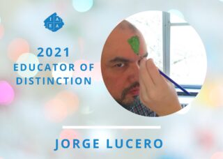 Jorge educator of distinction with someone painting green on his forehead