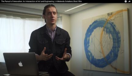 Sebastien Johnson talking with painting to side