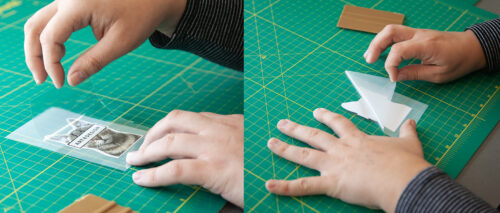 hands applying transfer tape to printed vinyl