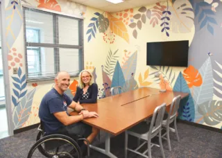 Bleakney and McDonagh sitting at table in studio at Beckman