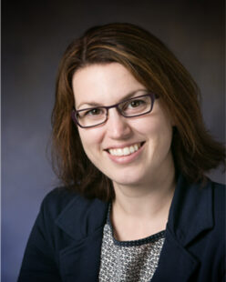 Jennifer Amos in front of a gray backdrop