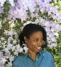 Smiling student amid lavender blooms on a tree