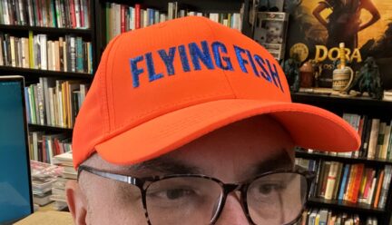 portrait of Lucero in his office wearing baseball cap