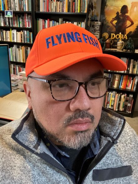 portrait of Lucero in his office wearing baseball cap
