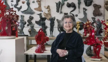 Ruth Migdal in front of her sculptures