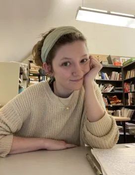 young woman sitting at a desk 