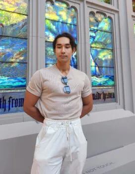 image of young man in front of stained glass window