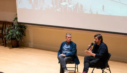 font bas and bianchi sitting on chairs on a stage