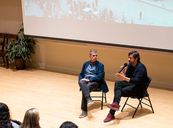 font bas and bianchi sitting on chairs on a stage