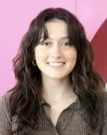 Portrait of the smiling designer with a pink background